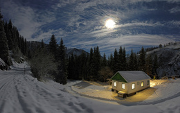 3d обои В глубине леса утопает в снегу дом с ярко освещёнными окнами, над ним сквозь облака пробивается свет полной луны  зима